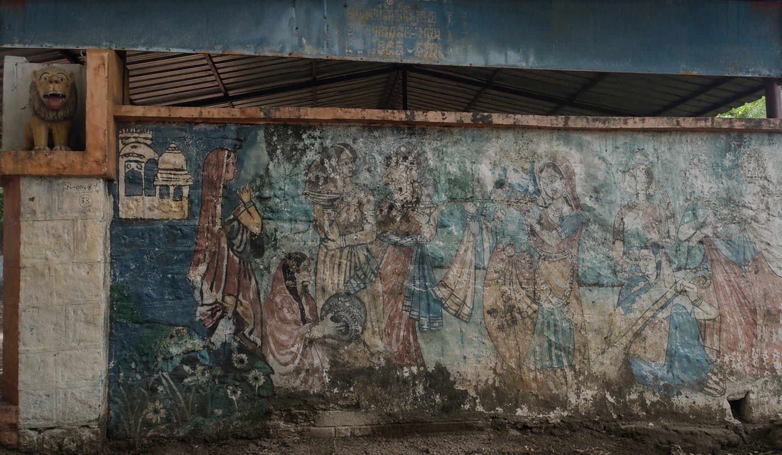 A faded mural on the boundary wall